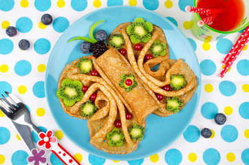 Funny Butterfly face pancakes with berries and fruits for kids' snack food