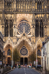 Illuminated by sun central facade of Reims cathedral, France
