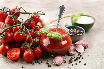 Fresh cherry tomato sauce on rustic background with cherry tomatoes.