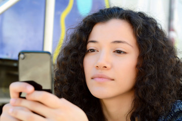 Young women sending message with smartphone.