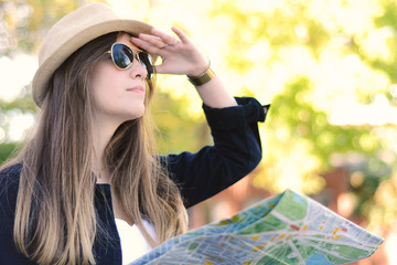 Tourist woman looking forward with map