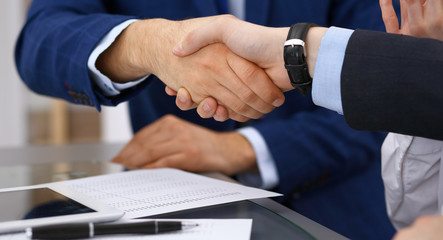 Business people shaking hands, finishing up a meeting. Audit, tax service or agreement concept