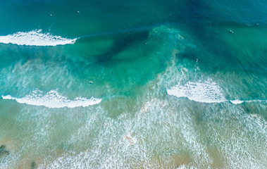 Aerial view of people surfing on a beach in Asturias