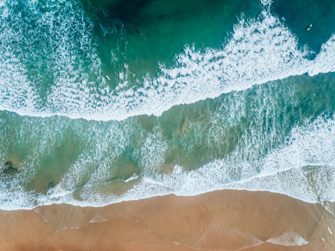 Aerial view of people surfing on a beach in Asturias