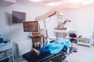 Eye surgery. A patient and surgeon in the operating room during ophthalmic surgery. Vision correction