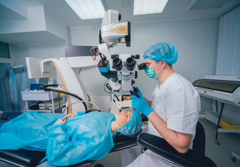 Eye surgery. A patient and surgeon in the operating room during ophthalmic surgery. Vision...