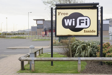 Free wi-fi wifi sign no charge to access the internet in hotel car park entrance for guests tourists people on holiday using facilities