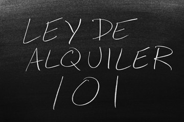 The words Ley De Alquiler 101 on a blackboard in chalk