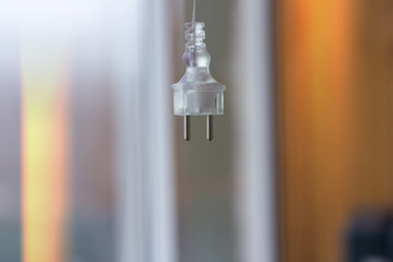 Electric plug on a blurred background hangs