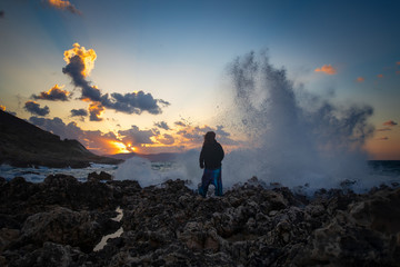 Strong woman at a stormy sea. Sunset over Mediterranean. Facing your fears