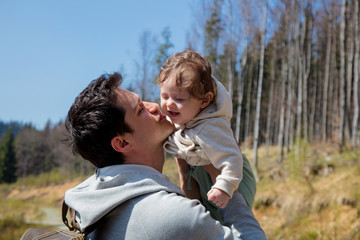Young father and child have a fun together at outdoor in forest