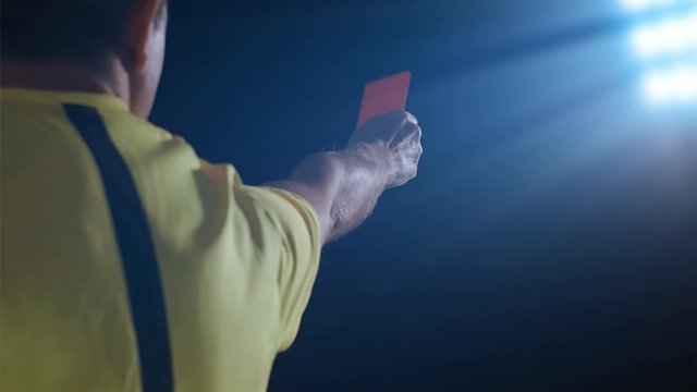 Football soccer referee shows penalty red card