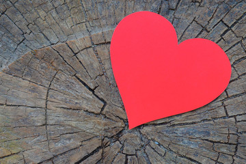 Red heart on a background of  beautiful wood texture with cracks