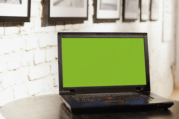 Laptop computer on table at coworking office space