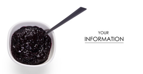 Blueberries jam in a white pial bowl with a teaspoon pattern