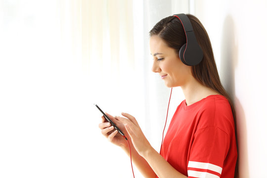 Girl listening to music on white at side