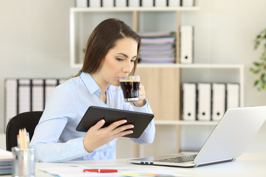 Office worker working online and drinking coffee