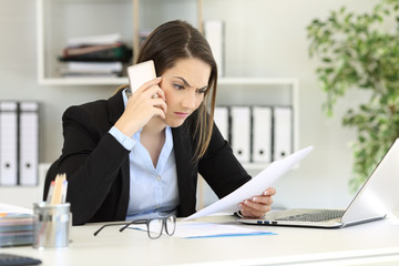 Angry executive calling on phone at office