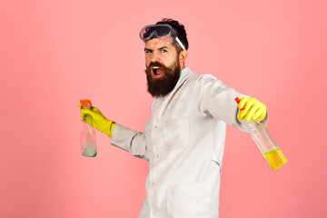 Angry bearded man with cleaning equipment. Man with foam on head. Isolated on pink background. Bearded man with cleaning spray. Cleaning concept. Copy space for advertise cleaning company.