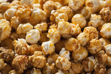 Golden caramel popcorn closeup. Background of popcorn. Snacks and food for a movie