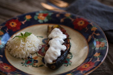 Stuffed eggplant with rice on colorful plate