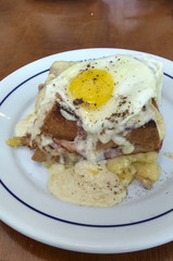 Sandwich with melted cheese, bacon, egg