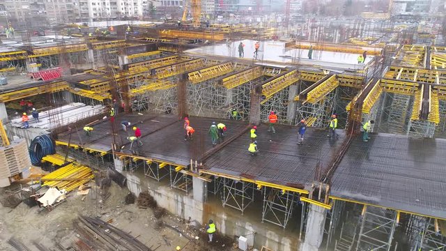 Aerial view on huge construction site with heavy equipment and workers.