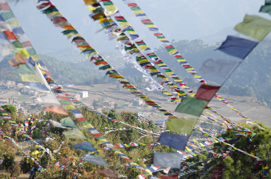 Colorful Buddhist Prayer flags waving on the wind at the hill top