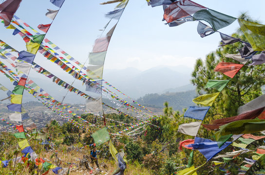 Colorful Buddhist Prayer flags waving on the wind at the hill top