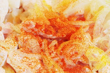 Preparing food meal - chicken meat, onion, curry. Close up. Macro view.