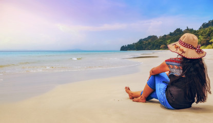 Fototapeta na wymiar Young female tourist enjoy sunset at Havelock Island beach Andaman, India.