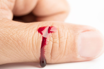 Drop of blood on finger human on white background wound injury accident health care medicine concept
