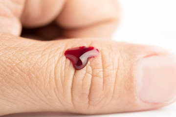 Drop of blood on finger human on white background wound injury accident health care medicine concept