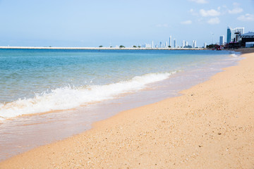 Beautiful clean beach and soft wave with modern building