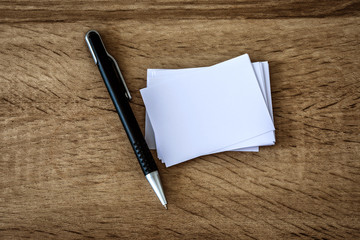 the stacking of mockup empty white business card with elegance pen  on wooden background , template for business  branding identity design