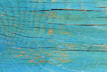 Old wooden background with remains of pieces of scraps of old paint on wood. Texture of an old tree, board with paint, vintage background peeling paint. old blue board with cracked paint, vintage