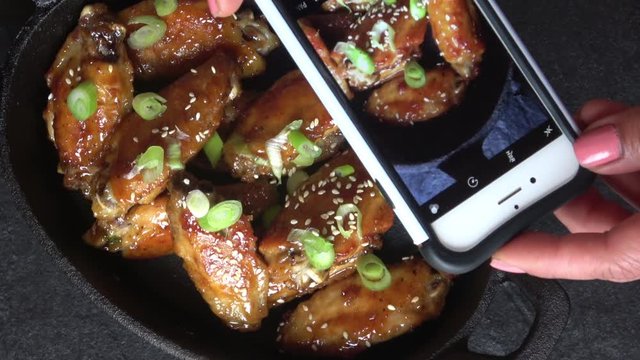 Food Photography of Chicken Wings Served in a Cast Iron Skillet