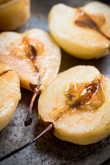 Grilled pears with cinnamon and honey on the rustic background. Selective focus.