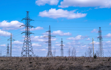 high voltage lines, spring grass and beautiful clouds