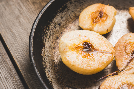 Grilled pears with cinnamon and honey on the rustic background. Selective focus.