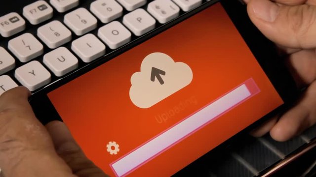 Browsing or watching on a smartphone: uploading a file or resource to the cloud. Rainbow background.
