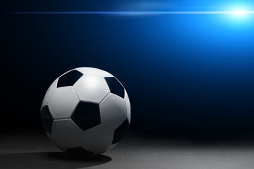 Naklejka premium Soccer ball on the black background