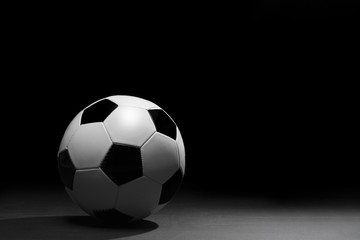 Soccer ball on the black background