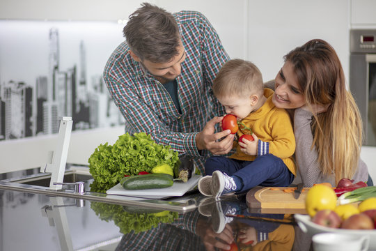 Happy Family Preparing Vegetables Together At Home In The Kitchen