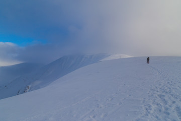 Beautiful  winter scenery in the mountains, with fresh snow, and mist, on a bright sunny day