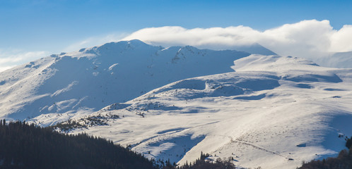 Fototapeta na wymiar Bright winter scenery in the Alps with fresh snow