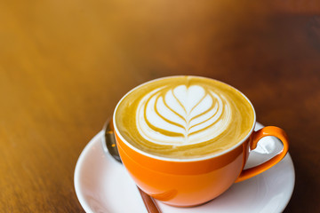 latte art coffee on wooden table