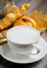 Breakfast with coffee, croissants and grilled pears with honey. Selective focus.