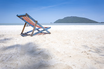 Beach chair on the white beach with beautiful blue sky
