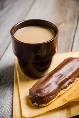 Cup of coffe with cake on thw rustic wooden background. Selective focus.